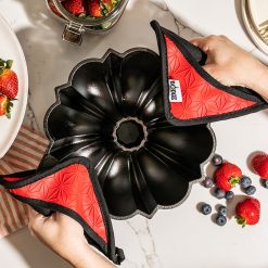 Alternative view of Lodge Cast Iron Fluted Cake Pan with Red Potholders